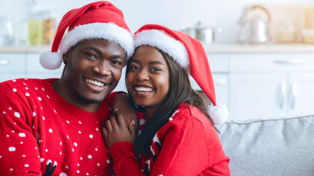 Couple Celebrating Christmas in Cozy Sweaters and Santa Hats at Homeの写真素材