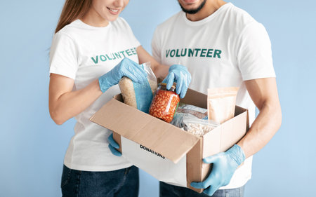 Couple Volunteering Together to Support Community Food Donation Effortsの写真素材