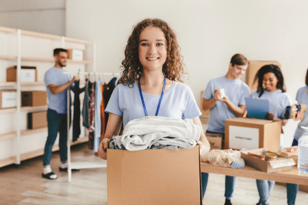 Volunteers Organize Donations in a Community Center During a Charity Eventの写真素材