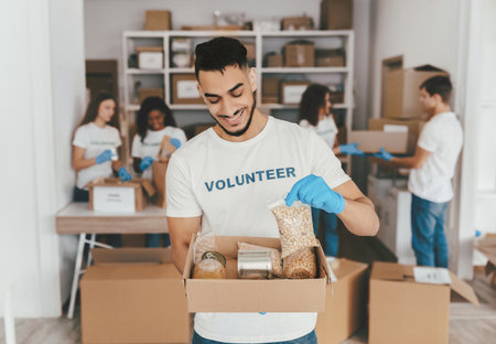 Volunteer Group Sorting Food Items in a Community Service Activityの写真素材