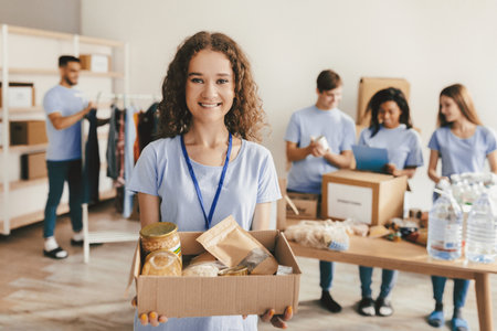 Community Volunteers Help Organize Food Packages for Those in Need During a Charity Event