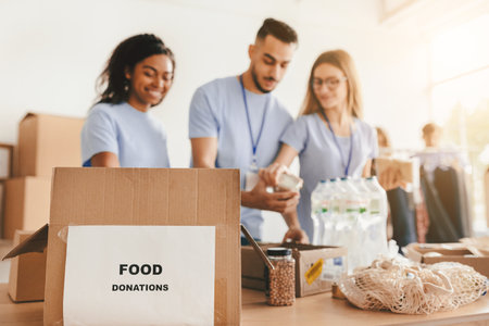Volunteers Prepare Food Donations in a Community Center During a Charity Eventの写真素材