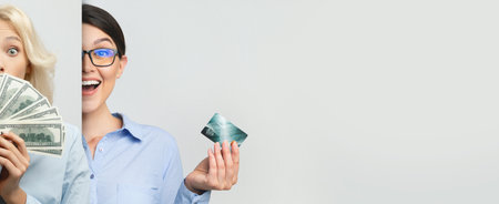 Business People Celebrating Success With Cash and Credit Cards in a Professional Settingの写真素材