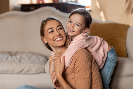 Mother and Daughter Share a Joyful Moment While Playing Together in a Cozy Living Room Settingの写真素材