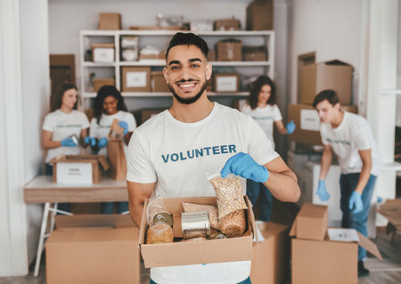 Volunteers Organize Food Items in a Community Service Project at a Donation Centerの写真素材