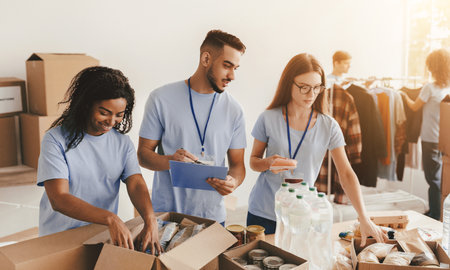 Volunteers Organize Supplies in Community Center During Afternoon Event for Local Charity Workの写真素材