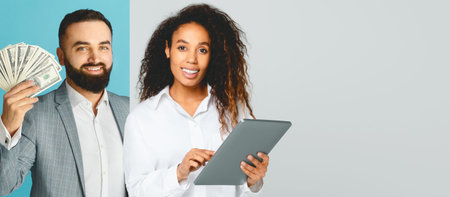 Business Professionals Collaborating in a Modern Office Setting With Technology and Moneyの写真素材