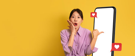 Excited Woman Interacts With Social Media on Her Smartphone in a Vibrant Settingの写真素材