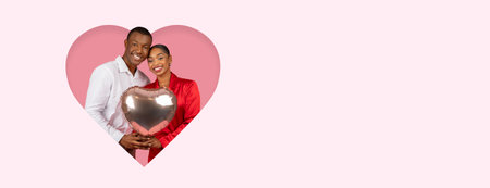 Happy Couple Celebrating Love With a Heart-Shaped Balloon on a Pink Backgroundの写真素材