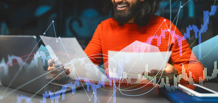 Happy Indian Manager Reviewing Marketing Report in Casual Office Settingの写真素材