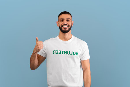 Volunteer Proudly Showing Support With a Smile Against a Light Blue Backgroundの写真素材