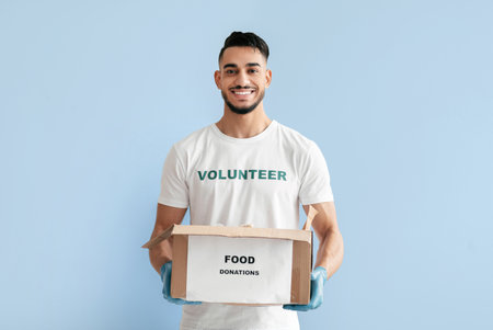 Volunteer Supports Community by Collecting Food Donations in a Bright Settingの写真素材