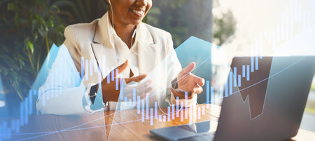 Business Professional Engages in Virtual Meeting With Financial Graphics in Modern Office Settingの写真素材