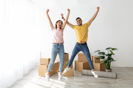 Excitement Fills the Air as a Couple Celebrates Moving Into Their New Homeの写真素材
