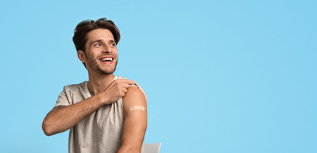 Young Man Smiles and Shows off a Bandage on His Arm After Receiving a Vaccine at a Health Clinic