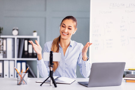 Woman Engaging in Online Video Lesson at Home Office