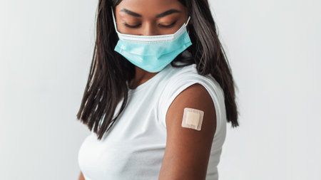 Vaccinated Black Female In Mask Showing Shoulder With Adhesive Bandage