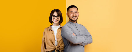 People Standing Together in a Bright Studio With Yellow Backgrounds and Smilesの写真素材