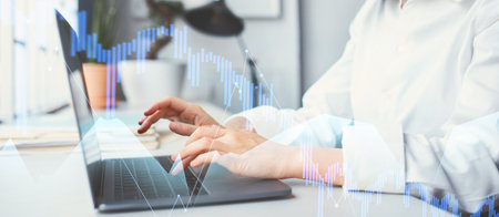 Young Businesswoman Focuses on Laptop While Analyzing Data in Modern Office Setting
