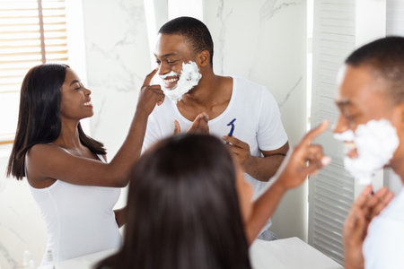 Couple Enjoying Grooming Time Together in a Bright Bathroomの写真素材