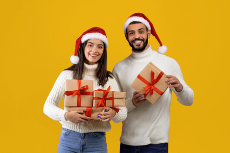 Couple Celebrating Christmas With Gifts and Festive Hats on a Cheerful Yellow Background