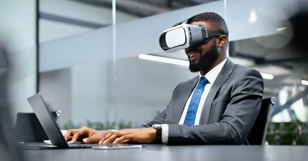 Businessman Uses Virtual Reality Headset While Working at Desk in Modern Office Space