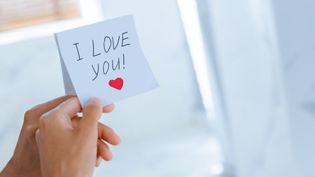 Handwritten Note Expressing Love in a Bright, Cozy Settingの写真素材