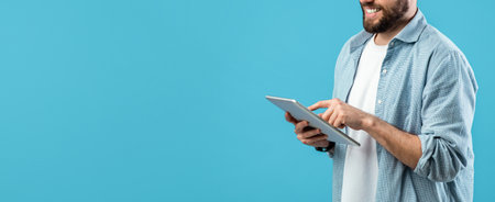 Man Using Tablet With Smiling Expression Against Bright Blue Background