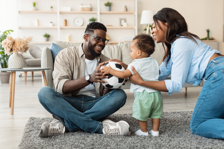 Portrait of Joyful Black Family Playing Together on Living Room Carpet at Homeの写真素材