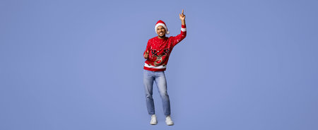 Man in Festive Sweater Dances Joyfully Against a Bright Blue Background