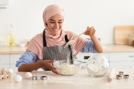 Cooking With Joy in a Bright Kitchen While Making Dough From Scratch in the Morningの写真素材