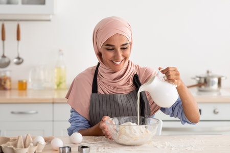 Woman Preparing Dough in a Modern Kitchen With Excitement and Skill in a Bright, Clean Spaceの写真素材