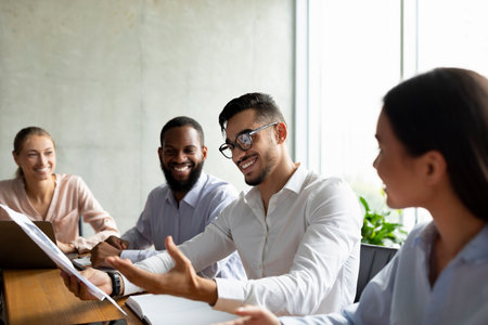 Group of Diverse Coworkers Collaborating on a New Project During a Corporate Meeting in an Officeの写真素材