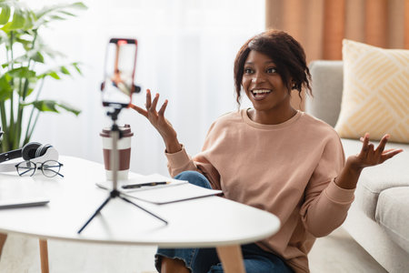 Young Woman Engages in Lively Video Chat at Home, Sharing Ideas and Insights With an Audience During...