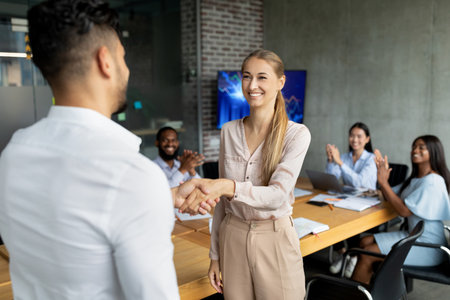 Boss Welcomes New Employee With Handshake During Corporate Meeting in Officeの写真素材