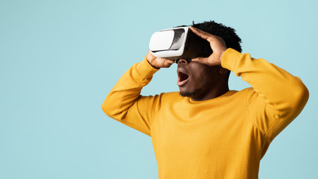 Excited young black man having virtual reality glasses experience