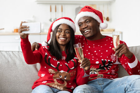 Happy Couple Celebrates New Year by Taking a Selfie at Home Wearing Festive Attireの写真素材