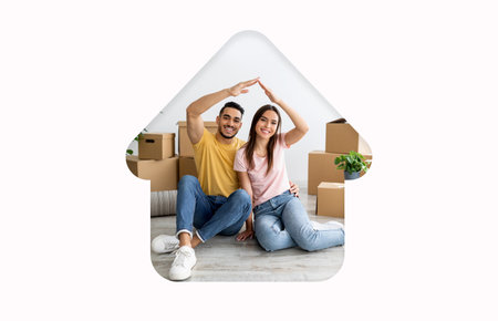 Couple Celebrating New Home With Playful Gesture Over Moving Boxes in Cozy Living Space