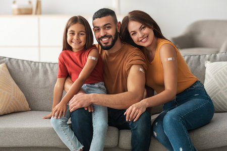 Happy Family Shows off Vaccine Bandages After Receiving Covid-19 Vaccinations Togetherの写真素材