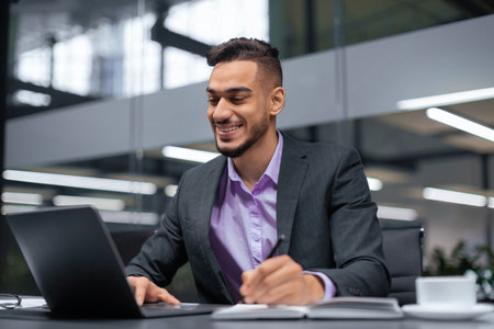 Business Professional Works on Laptop at Modern Office During Midday With Focus and Engagementの写真素材