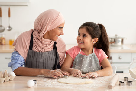 Enjoying Quality Time Making Dough Together in a Cozy Kitchen With a Smiling Mother and Daughter