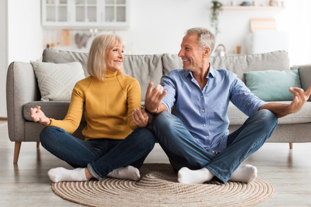 Elderly Couple Enjoying Quality Time Together in Cozy Living Room While Sitting on Floor