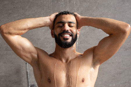 Young Arabic Male Model Enjoys a Refreshing Shower in a Modern Bathroom