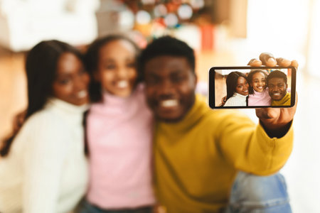 Family Takes a Selfie Together at Home During a Cheerful Moment in the Living Room
