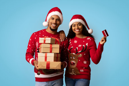 Smiling Couple in Festive Sweaters Holding Gifts During Holiday Season Indoorsの写真素材