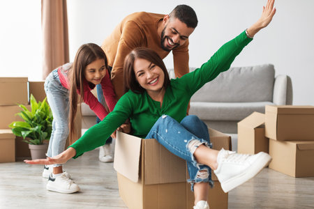 Cheerful Arab Family Enjoys Fun Activities on Moving Day in Their New Apartment