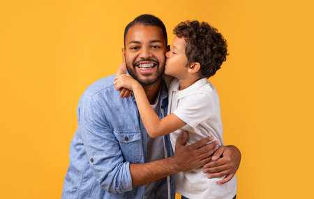 Love My Dad. Preteen Boy Kissing His Happy Fatherの写真素材
