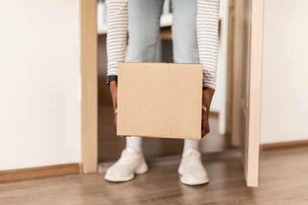 Lady Taking Cardboard Parcel Box From Floor Entering House
