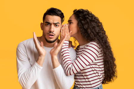 Young Arab Woman Sharing Gossips With Her Shocked Boyfriend,