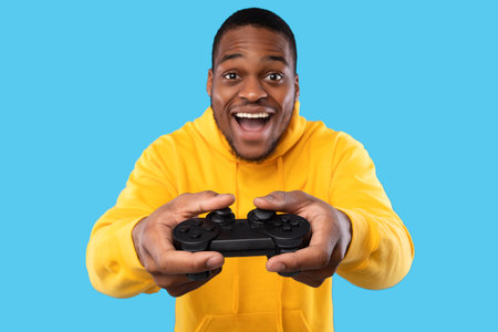 African American Guy Playing Videogame Posing With Joystick, Blue Background